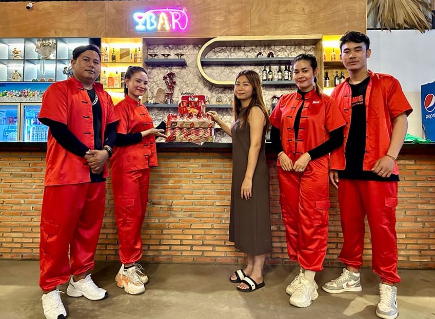 Yeos New Can Design, Year of the Dragon, Chinese New Year - Yeo's employees standing with cans at a bar